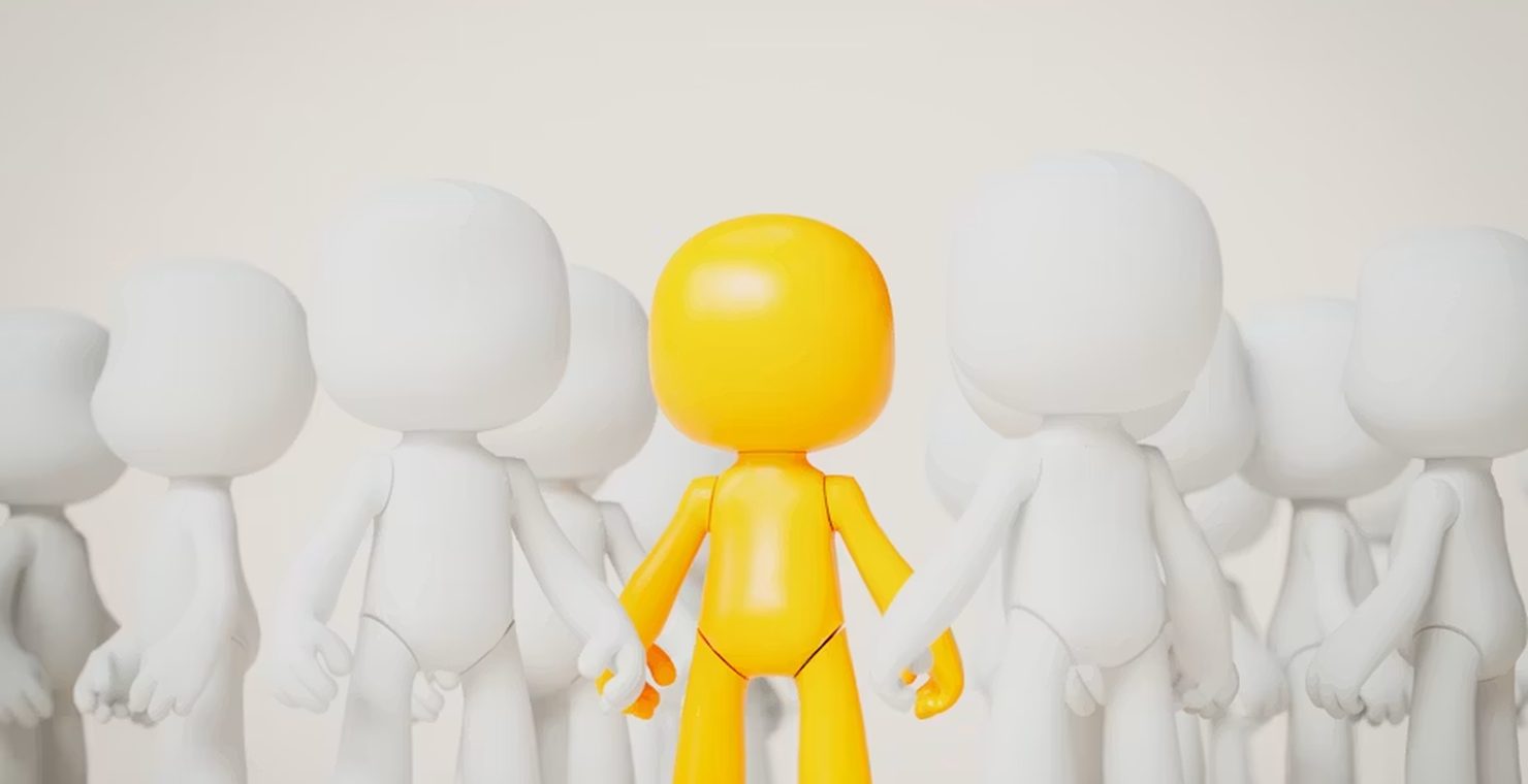 A single gold figure standing out from a crowd of identical white figures